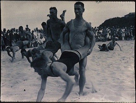 men in human wheelbarrow race